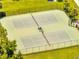 Aerial view of tennis courts with green surface and manicured surroundings at 9997 Town Lake Dr, Orlando, FL 32832