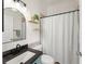 Cozy bathroom with black hardware, decorative shelves, and shower with curtain at 10254 Hart Branch Cir, Orlando, FL 32832