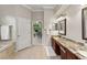 Bathroom featuring an ensuite office view, a large vanity, and a soaking tub at 10254 Hart Branch Cir, Orlando, FL 32832