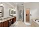 Bathroom featuring a large vanity with dual sinks and a separate shower at 10254 Hart Branch Cir, Orlando, FL 32832