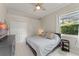 Bedroom with a ceiling fan, closet, window, and dark colored furniture at 10254 Hart Branch Cir, Orlando, FL 32832
