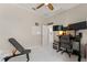 Bedroom featuring a ceiling fan, a desk with monitors, and fitness equipment at 10254 Hart Branch Cir, Orlando, FL 32832