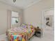Bedroom with a ceiling fan, closet, window, and a side table at 10254 Hart Branch Cir, Orlando, FL 32832