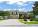 Elegant two-story home features a well-maintained lawn, mature landscaping, and a spacious driveway for multiple vehicles at 10254 Hart Branch Cir, Orlando, FL 32832