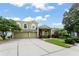Charming two-story home with a manicured lawn, mature trees, and a spacious driveway leading to a three-car garage at 10254 Hart Branch Cir, Orlando, FL 32832