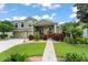 Charming two-story home boasts a lush, landscaped yard and a welcoming double-door entrance, blending elegance with curb appeal at 10254 Hart Branch Cir, Orlando, FL 32832