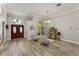 Inviting foyer with wood-look tile flooring and decorative lighting fixture at 10254 Hart Branch Cir, Orlando, FL 32832
