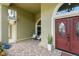 Charming covered front porch with stone flooring and double entry door at 10254 Hart Branch Cir, Orlando, FL 32832