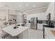 Bright, updated kitchen with stainless steel appliances, large island with seating, and modern finishes at 10254 Hart Branch Cir, Orlando, FL 32832