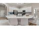 Bright, open kitchen featuring white cabinetry, stainless appliances, and large center island with bar seating at 10254 Hart Branch Cir, Orlando, FL 32832