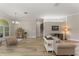 Spacious living room with wood-look tile flooring, a stylish light fixture, and comfortable seating arrangements at 10254 Hart Branch Cir, Orlando, FL 32832