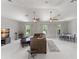Open living room with vaulted ceilings, dual fans, ample seating, and an adjacent dining area at 10254 Hart Branch Cir, Orlando, FL 32832