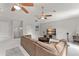 Expansive living room with a vaulted ceiling, comfortable seating, and an entertainment center at 10254 Hart Branch Cir, Orlando, FL 32832