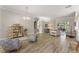 Open-concept living room with wood-look tile floors and access to dining area at 10254 Hart Branch Cir, Orlando, FL 32832