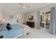 Spacious main bedroom with ceiling fan, TV, and access to the patio at 10254 Hart Branch Cir, Orlando, FL 32832