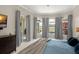 Bright main bedroom featuring a sitting area with lots of natural light and a sliding glass door at 10254 Hart Branch Cir, Orlando, FL 32832