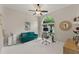Bright office with a ceiling fan, a modern desk, and a comfortable green sofa under a large window at 10254 Hart Branch Cir, Orlando, FL 32832