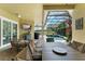 Inviting covered patio with ample seating, a television, grill, and a view of the screened pool at 10254 Hart Branch Cir, Orlando, FL 32832
