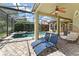 Relax on the patio with chaise lounges overlooking the pool, complete with a ceiling fan for optimal comfort at 10254 Hart Branch Cir, Orlando, FL 32832