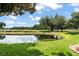 Scenic pond view with golf course in background offering a peaceful connection with nature and recreational opportunity at 10254 Hart Branch Cir, Orlando, FL 32832
