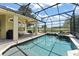 The screened-in pool with jacuzzi offers a private retreat with scenic views of the adjacent pond and golf course at 10254 Hart Branch Cir, Orlando, FL 32832