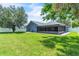 A well-maintained backyard with lush grass, brick patio, and screened in patio area at 1031 Seneca Trl, St Cloud, FL 34772