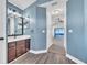 Bathroom with double vanity, natural light, and view into the bedroom at 1031 Seneca Trl, St Cloud, FL 34772