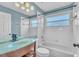 Stylish bathroom featuring a glass bowl sink, tub, and neutral tiling at 1031 Seneca Trl, St Cloud, FL 34772
