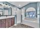 Bright bathroom featuring a tub, separate shower, and double vanity at 1031 Seneca Trl, St Cloud, FL 34772