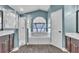 Bathroom with tub, enclosed shower, double sink vanity, and natural light at 1031 Seneca Trl, St Cloud, FL 34772