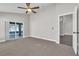 Bedroom with sliding glass doors to lanai, neutral walls, carpet, and ceiling fan at 1031 Seneca Trl, St Cloud, FL 34772