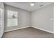 Bright bedroom with neutral walls, carpet, and natural light from window at 1031 Seneca Trl, St Cloud, FL 34772