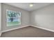 Neutral bedroom features carpeting, window with a view, and ceiling fan at 1031 Seneca Trl, St Cloud, FL 34772