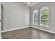 Serene bedroom featuring two large arched windows providing ample natural light and hardwood flooring at 1031 Seneca Trl, St Cloud, FL 34772