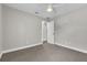Bedroom with ceiling fan, neutral walls, carpet, and doorway to bathroom at 1031 Seneca Trl, St Cloud, FL 34772