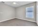Bedroom featuring neutral walls, carpeting, ceiling fan, and window at 1031 Seneca Trl, St Cloud, FL 34772