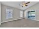 Bedroom with neutral walls, carpet, ceiling fan, and natural light from windows at 1031 Seneca Trl, St Cloud, FL 34772