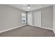 Neutral bedroom offers carpeting, ceiling fan, and double door closet at 1031 Seneca Trl, St Cloud, FL 34772