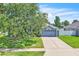 A charming one-story home with lush lawn, mature tree, and a two car garage at 1031 Seneca Trl, St Cloud, FL 34772
