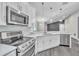 Modern kitchen featuring stainless steel appliances, light countertops and bright backsplash at 1031 Seneca Trl, St Cloud, FL 34772