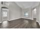 Spacious living room featuring hardwood flooring, arched doorways, and abundant natural light from scenic windows at 1031 Seneca Trl, St Cloud, FL 34772