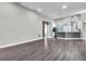 Open living area with wood-style flooring, and views into the kitchen at 1031 Seneca Trl, St Cloud, FL 34772