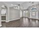 Open living space featuring hardwood floors, modern lighting, arched doorways and seamless flow into the kitchen at 1031 Seneca Trl, St Cloud, FL 34772