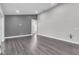 Open living room with wood-style flooring, neutral paint, and access to the outdoor lanai at 1031 Seneca Trl, St Cloud, FL 34772