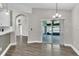 Bright living space featuring wood-style flooring, an elegant chandelier and sliding door access to lanai at 1031 Seneca Trl, St Cloud, FL 34772