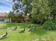 A lush green backyard features multiple peacocks and mature shade trees, offering a serene environment at 1032 Calanda Ave # 1032, Orlando, FL 32807