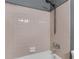Close-up of a shower and tub area featuring pink tile and a shower head at 1032 Calanda Ave # 1032, Orlando, FL 32807