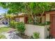 Charming home exterior with well-maintained landscaping, mature trees, and a private courtyard entrance at 1032 Calanda Ave # 1032, Orlando, FL 32807