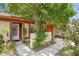 Charming single-story home featuring lush landscaping and inviting front entrance at 1032 Calanda Ave # 1032, Orlando, FL 32807