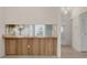 A view of the kitchen and pantry, seen through a pass-through, from the dining room at 1032 Calanda Ave # 1032, Orlando, FL 32807